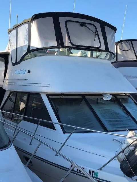 Slide: The Image of 2000 Bayliner 4087 Aft Cabin Motoryacht with enclosed flybridge, docked in marina. - 2