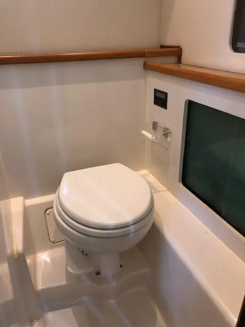 Slide: The Image of Bayliner 4087 Aft Cabin Motoryacht 2000 bathroom with toilet and wooden accents. - 20