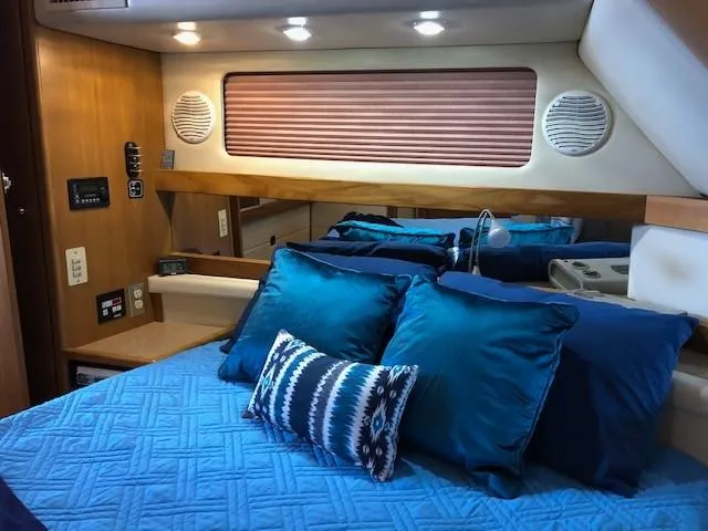 Slide: The Image of Bayliner 4087 Aft Cabin Motoryacht 2000 interior with blue bedding and modern amenities. - 25