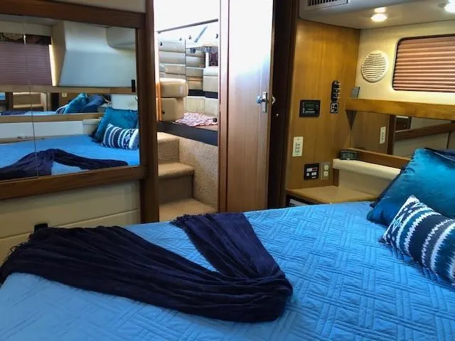 Slide: The Image of Interior of 2000 Bayliner 4087 Aft Cabin Motoryacht with blue bedding and wood accents. - 27