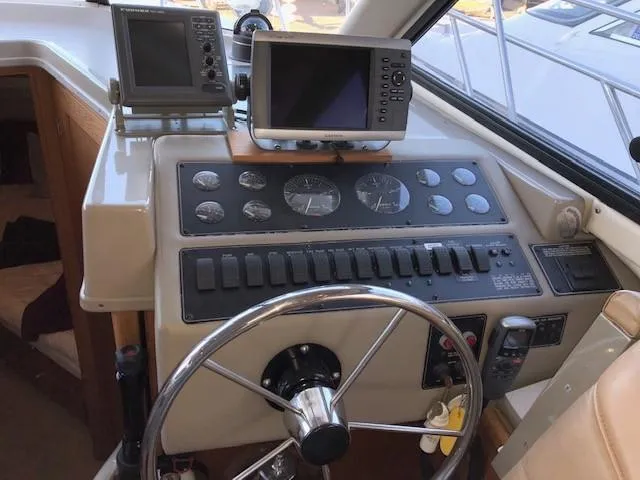 Slide: The Image of 2000 Bayliner 4087 Aft Cabin Motoryacht helm with navigation instruments and steering wheel. - 32