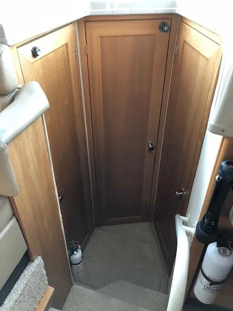 Slide: The Image of Interior view of 2000 Bayliner 4087 Aft Cabin Motoryacht, featuring wooden cabinetry and carpeted stairs. - 37