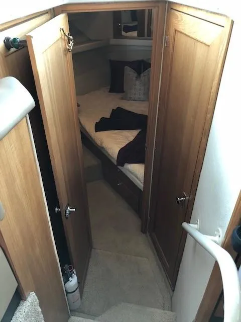 Slide: The Image of Interior view of 2000 Bayliner 4087 Aft Cabin Motoryacht bedroom with wooden doors and cozy bedding. - 38