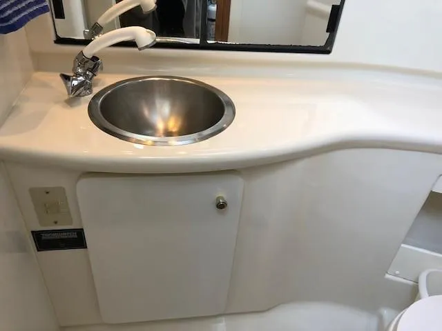 Slide: The Image of Aft cabin bathroom sink in 2000 Bayliner 4087 Motoryacht, featuring a stainless steel basin. - 47