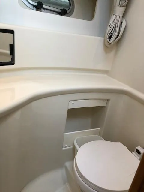 Slide: The Image of 2000 Bayliner 4087 Aft Cabin Motoryacht bathroom with toilet and porthole window. - 48