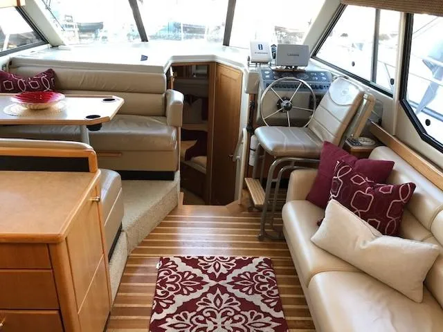 Slide: The Image of Interior of 2000 Bayliner 4087 Aft Cabin Motoryacht with seating, helm, and decorative accents. - 7
