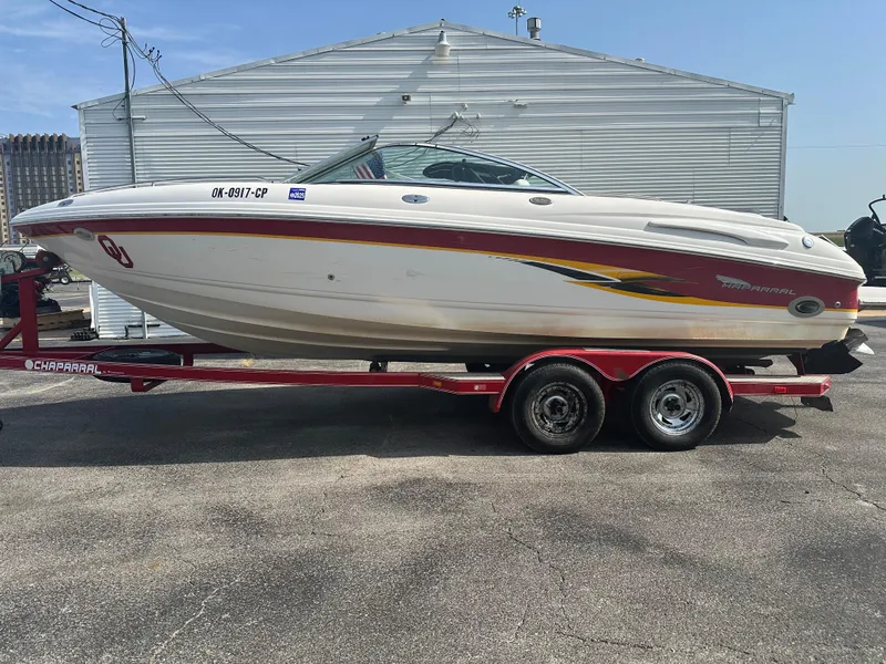 Slide: The Image of 2002 Chaparral 220WT SSi boat on red trailer, parked outdoors. - 1