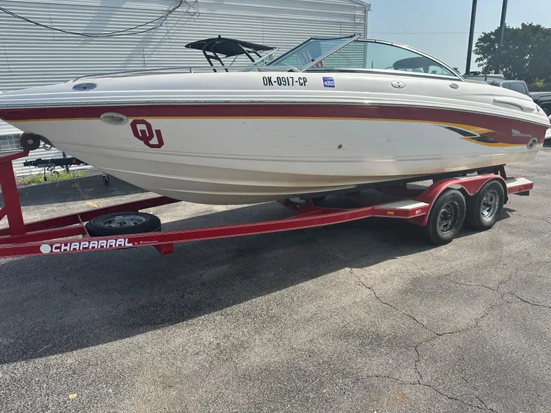 Slide: The Image of 2002 Chaparral 220WT SSi boat on red trailer, parked outdoors. - 2