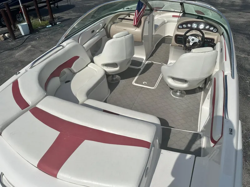 Slide: The Image of 2002 Chaparral 220WT SSi boat interior with white and red seating, American flag displayed. - 5