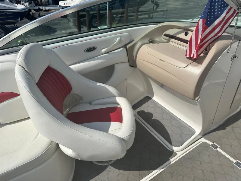 Slide: The Image of 2002 Chaparral 220WT SSi boat interior with white and red seating, American flag displayed. - 6
