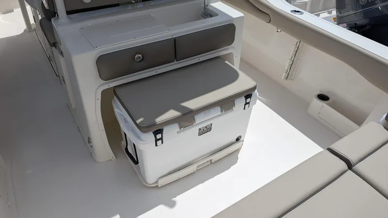 Slide: The Image of 2025 Key West 263 FS boat interior with storage and seating area. - 13