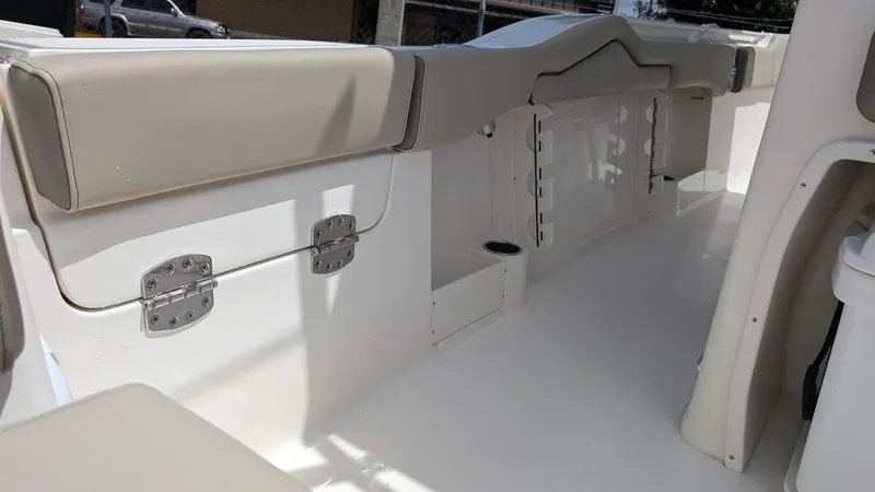 Slide: The Image of 2025 Key West 263 FS boat interior with beige seating and storage compartments. - 15