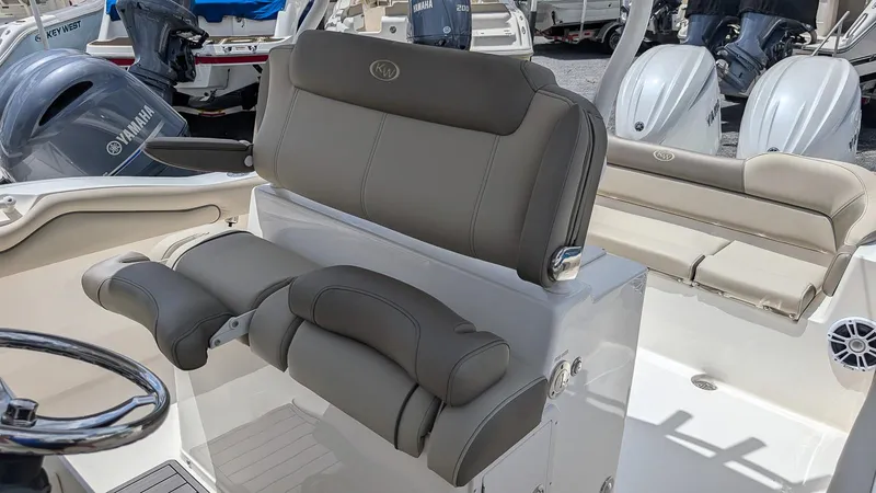Slide: The Image of 2025 Key West 263 FS boat interior with cushioned seating and steering wheel. - 16