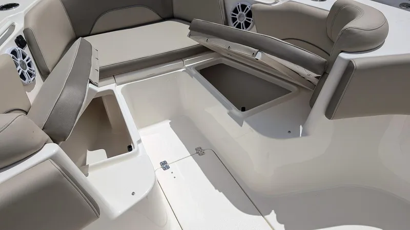 Slide: The Image of 2025 Key West 263 FS boat interior with open storage compartments and cushioned seating. - 22