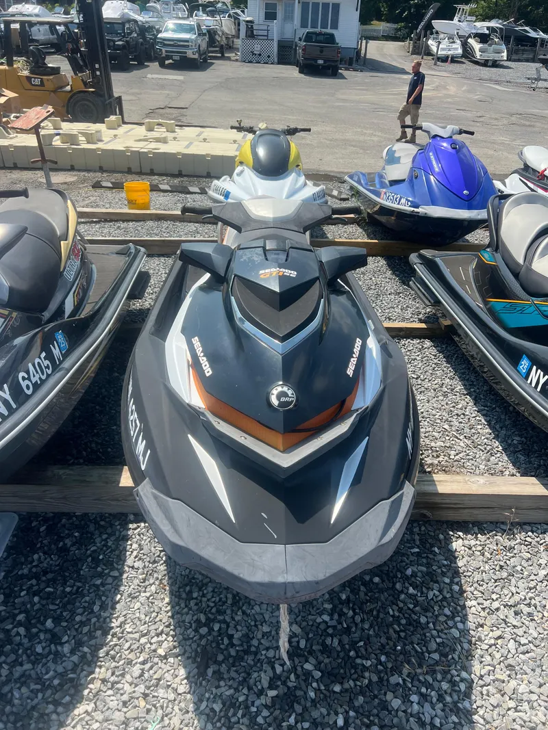 Slide: The Image of 2012 Sea-Doo GTI SE 130 jet ski on display at a marina. - 3