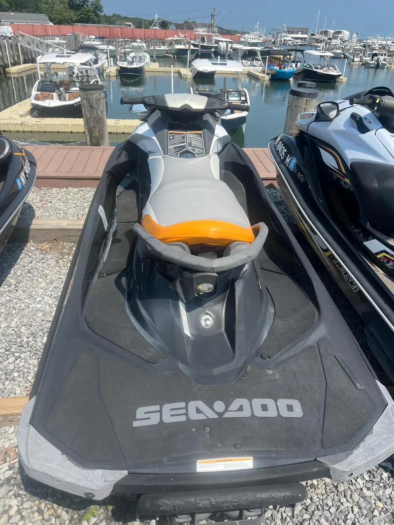 Slide: The Image of 2012 Sea-Doo GTI SE 130 jet ski docked at a marina. - 4