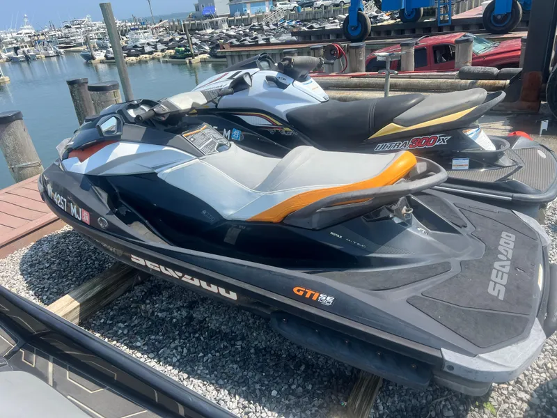 Slide: The Image of 2012 Sea-Doo GTI SE 130 jet ski docked at marina, ready for adventure. - 7