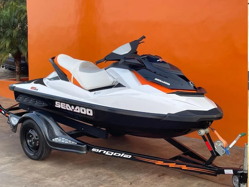 Slide: The Image of 2012 Sea-Doo GTI SE 130 jet ski on trailer, orange background. - 9