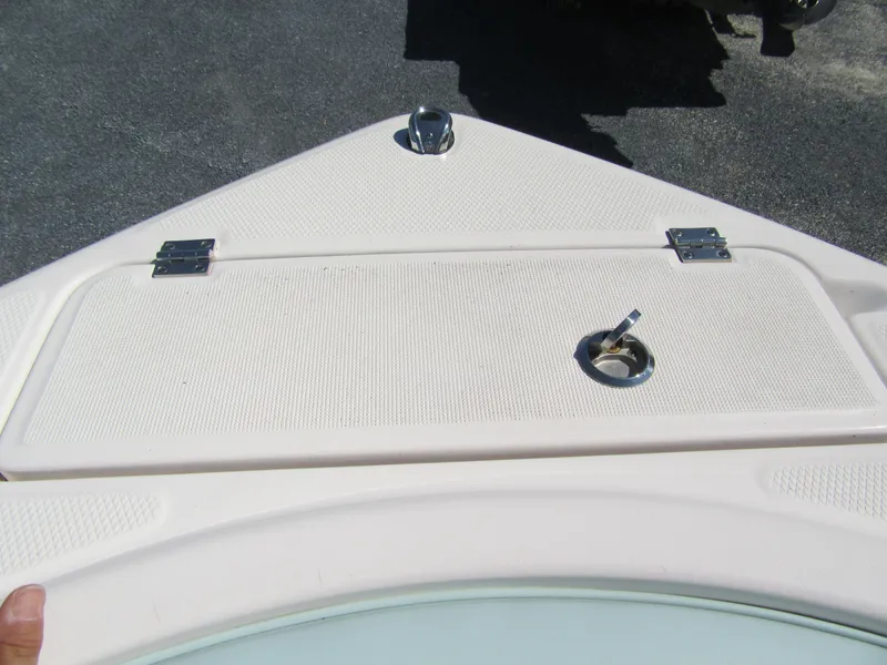 Slide: The Image of 2022 Robalo R222 Center Console boat deck with storage hatch and latch. - 10