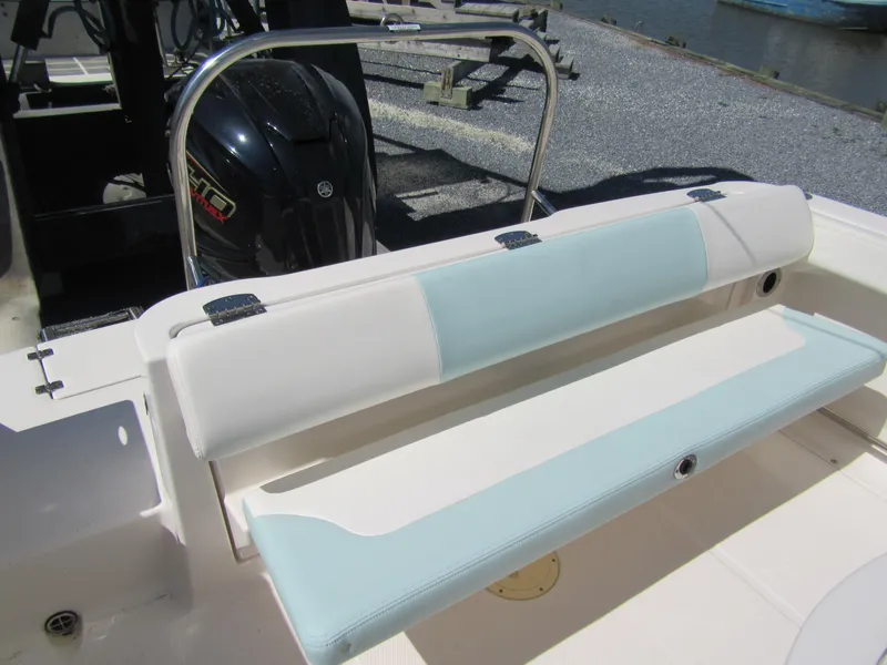 Slide: The Image of 2022 Robalo R222 Center Console boat seating with light blue and white cushions. - 4