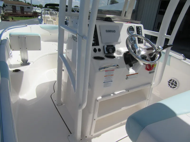 Slide: The Image of 2022 Robalo R222 Center Console boat interior with steering wheel and controls. - 5