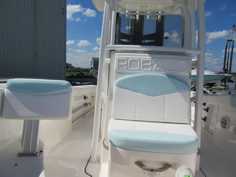 Slide: The Image of 2022 Robalo R222 Center Console boat interior with cushioned seating and console. - 6