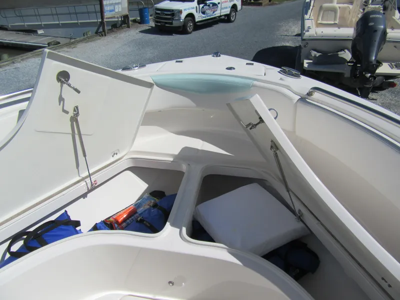Slide: The Image of 2022 Robalo R222 Center Console boat with open storage compartments. - 9