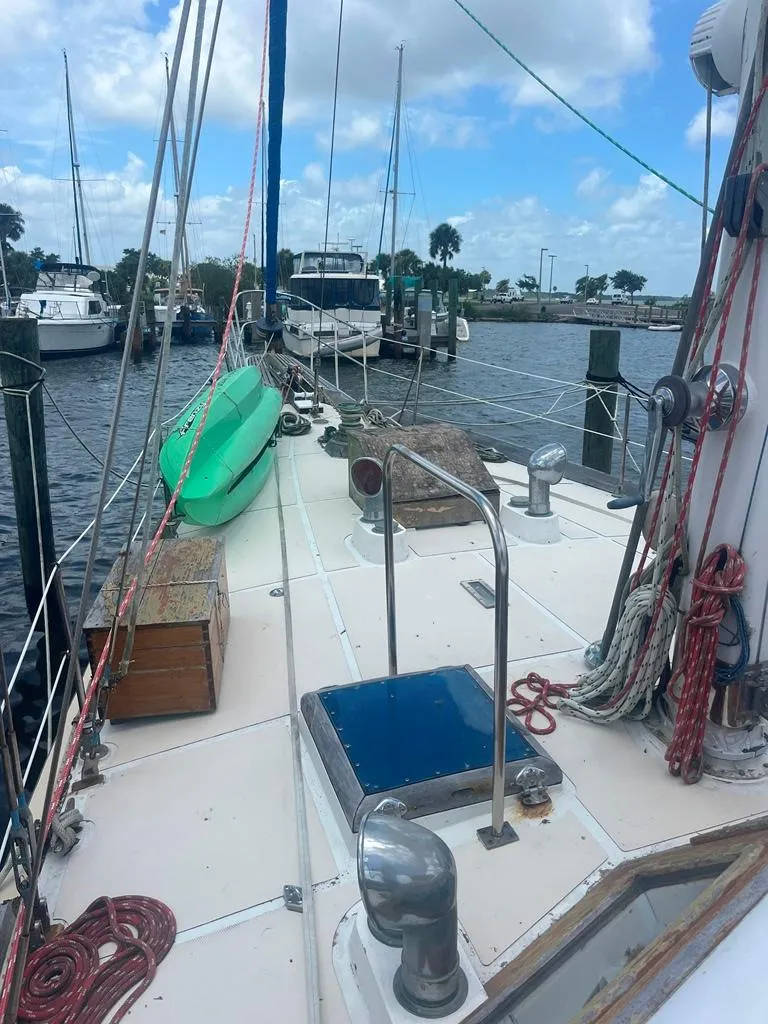 Slide: The Image of 1975 Cheoy Lee Offshore 53 MS sailboat docked, featuring deck view with ropes and equipment. - 14