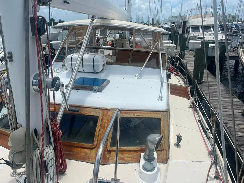 Slide: The Image of 1975 Cheoy Lee Offshore 53 MS sailboat docked at marina, showcasing deck and cabin. - 15