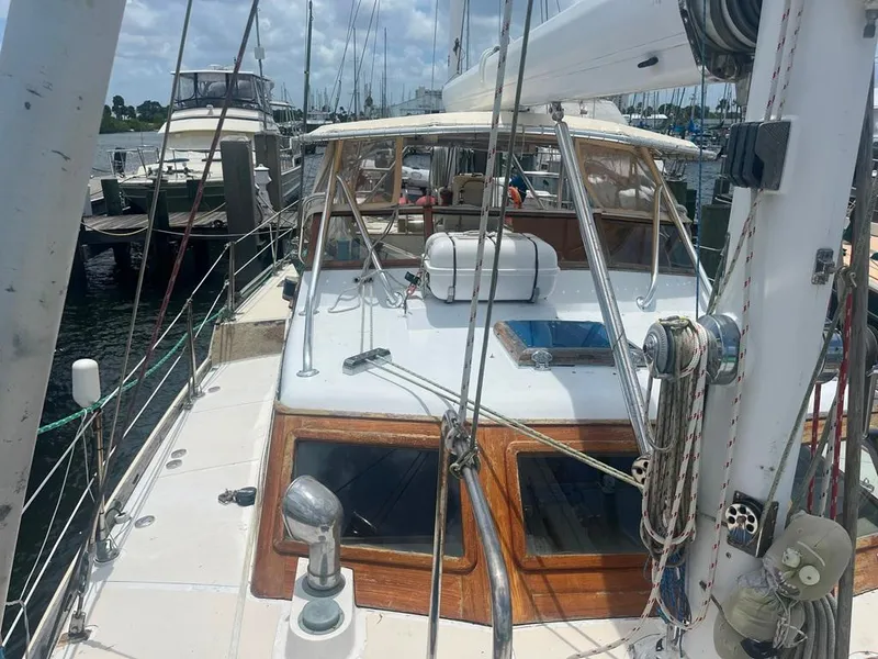 Slide: The Image of 1975 Cheoy Lee Offshore 53 MS sailboat docked at marina, showcasing deck and cabin features. - 16