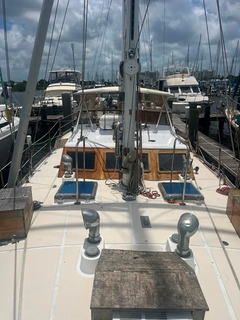 Slide: The Image of 1975 Cheoy Lee Offshore 53 MS sailboat docked at marina under cloudy sky. - 17