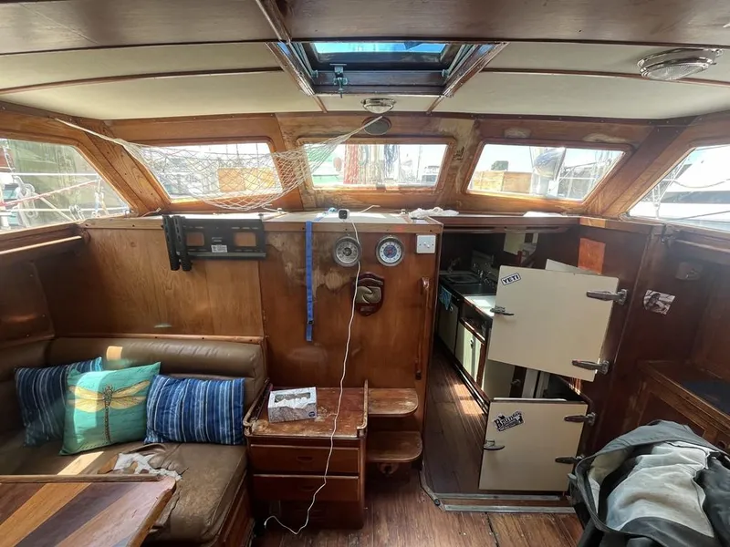 Slide: The Image of Interior of 1975 Cheoy Lee Offshore 53 MS sailboat with wood paneling and seating area. - 19