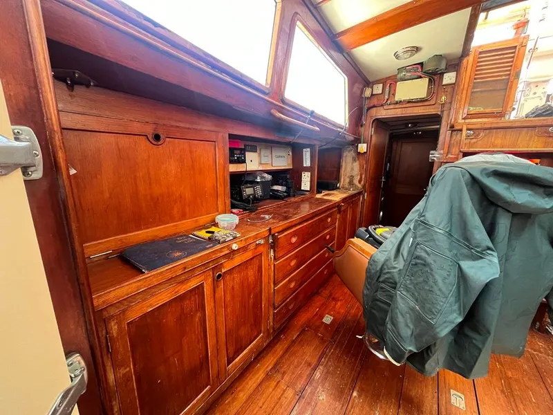 Slide: The Image of Interior of 1975 Cheoy Lee Offshore 53 MS sailboat with wooden cabinetry and cozy seating. - 21