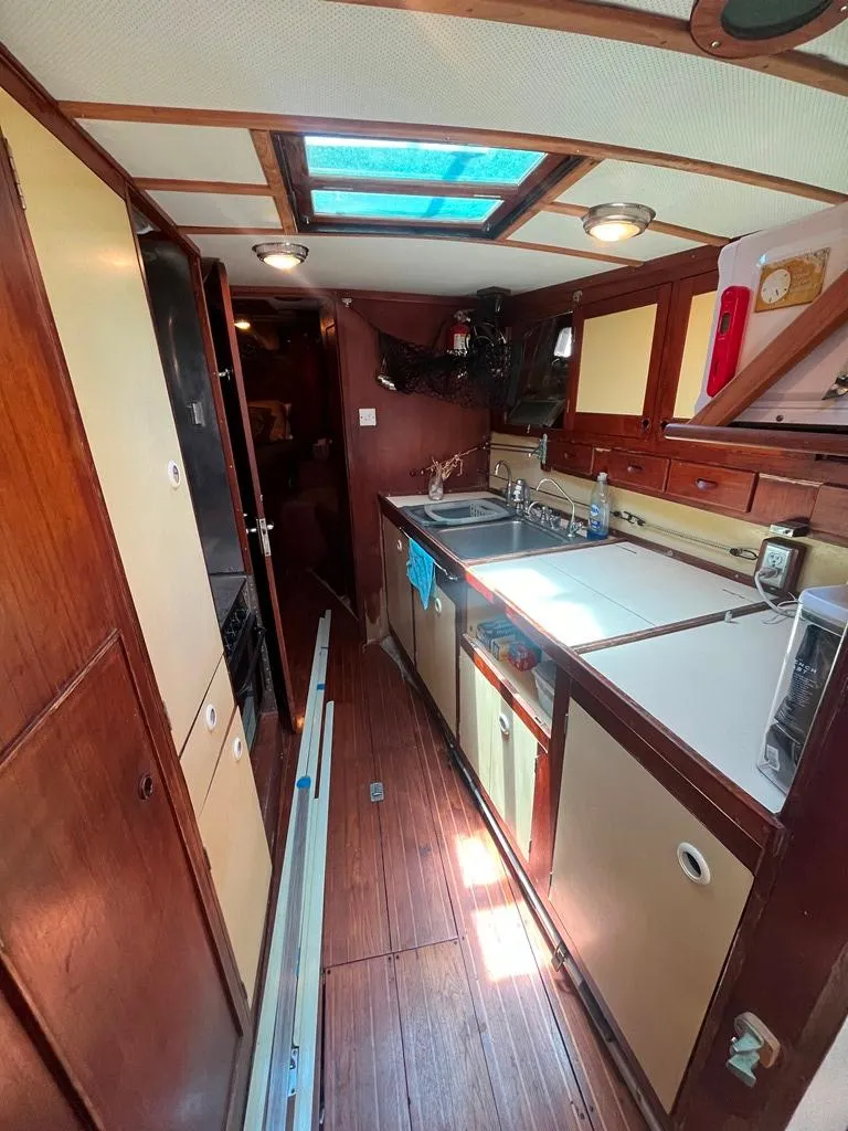 Slide: The Image of 1975 Cheoy Lee Offshore 53 MS yacht interior with wood cabinetry and skylight. - 22