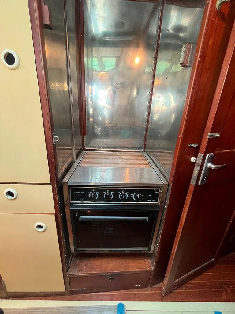 Slide: The Image of 1975 Cheoy Lee Offshore 53 MS yacht kitchen with stove and wooden cabinetry. - 24