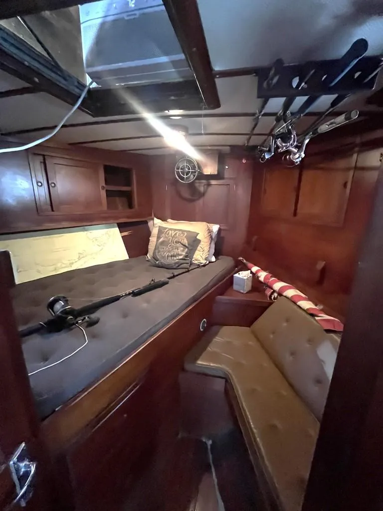 Slide: The Image of 1975 Cheoy Lee Offshore 53 MS cabin with wooden interior and fishing gear. - 27