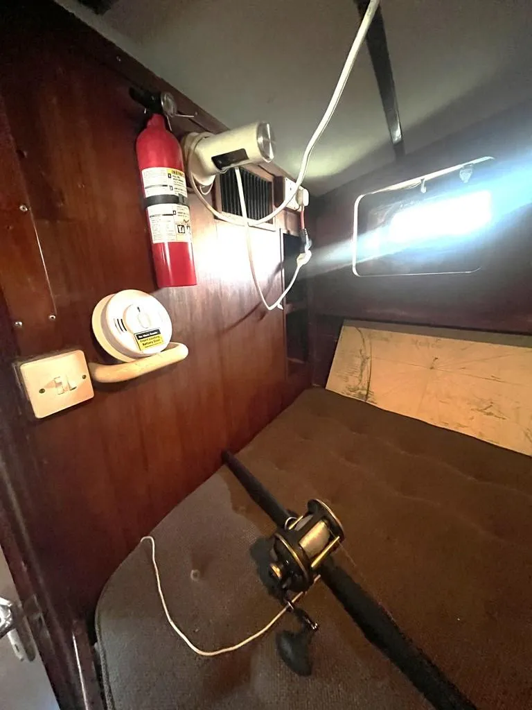 Slide: The Image of 1975 Cheoy Lee Offshore 53 MS cabin interior with fishing reel and safety equipment. - 28