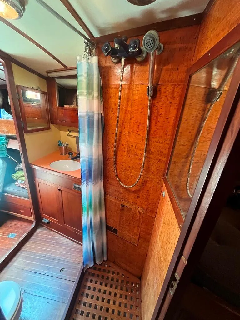 Slide: The Image of 1975 Cheoy Lee Offshore 53 MS yacht bathroom with wood paneling and shower. - 31