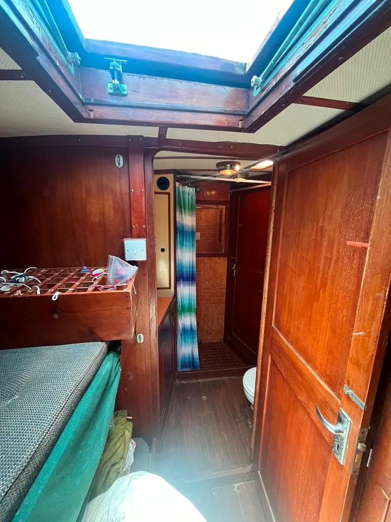 Slide: The Image of Interior of 1975 Cheoy Lee Offshore 53 MS sailboat with wooden paneling and colorful curtain. - 33