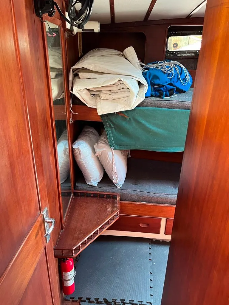 Slide: The Image of 1975 Cheoy Lee Offshore 53 MS cabin interior with wooden finish and bunk beds. - 34