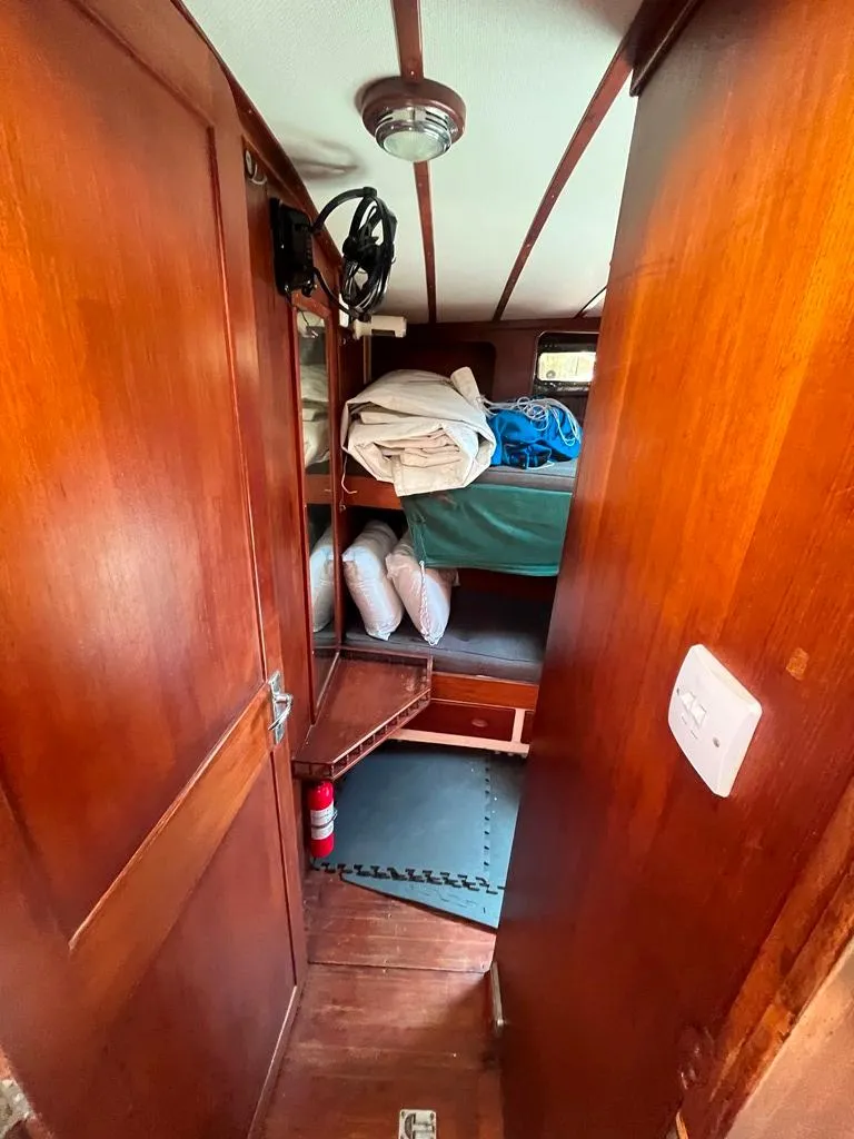 Slide: The Image of 1975 Cheoy Lee Offshore 53 MS cabin interior with wooden finish and bunk beds. - 35