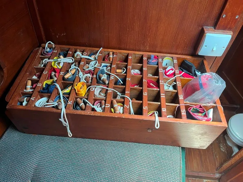 Slide: The Image of Wooden storage box with numbered compartments, filled with ropes and nautical items on a Cheoy Lee Offshore 53 MS. - 36