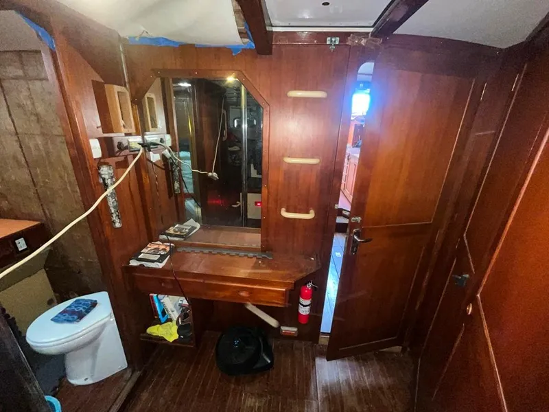 Slide: The Image of Interior of 1975 Cheoy Lee Offshore 53 MS yacht with wooden cabinetry and bathroom. - 38