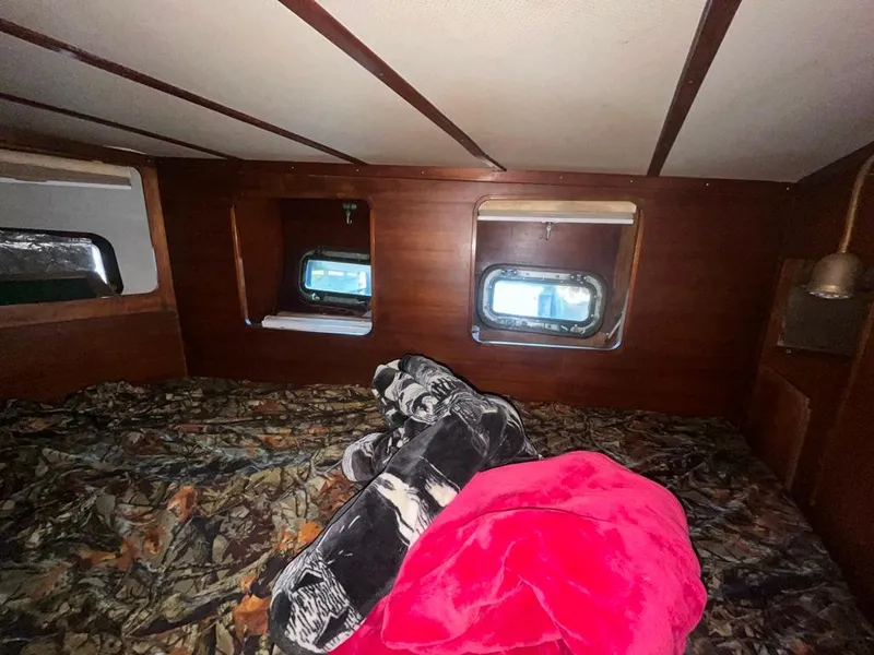 Slide: The Image of Interior cabin of 1975 Cheoy Lee Offshore 53 MS with cozy bedding and portholes. - 39