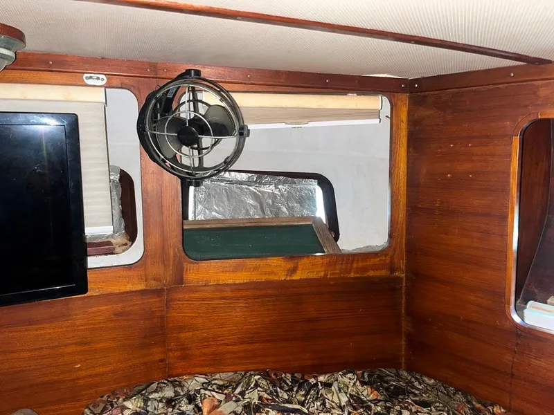 Slide: The Image of 1975 Cheoy Lee Offshore 53 MS cabin interior with wood paneling and fan. - 41