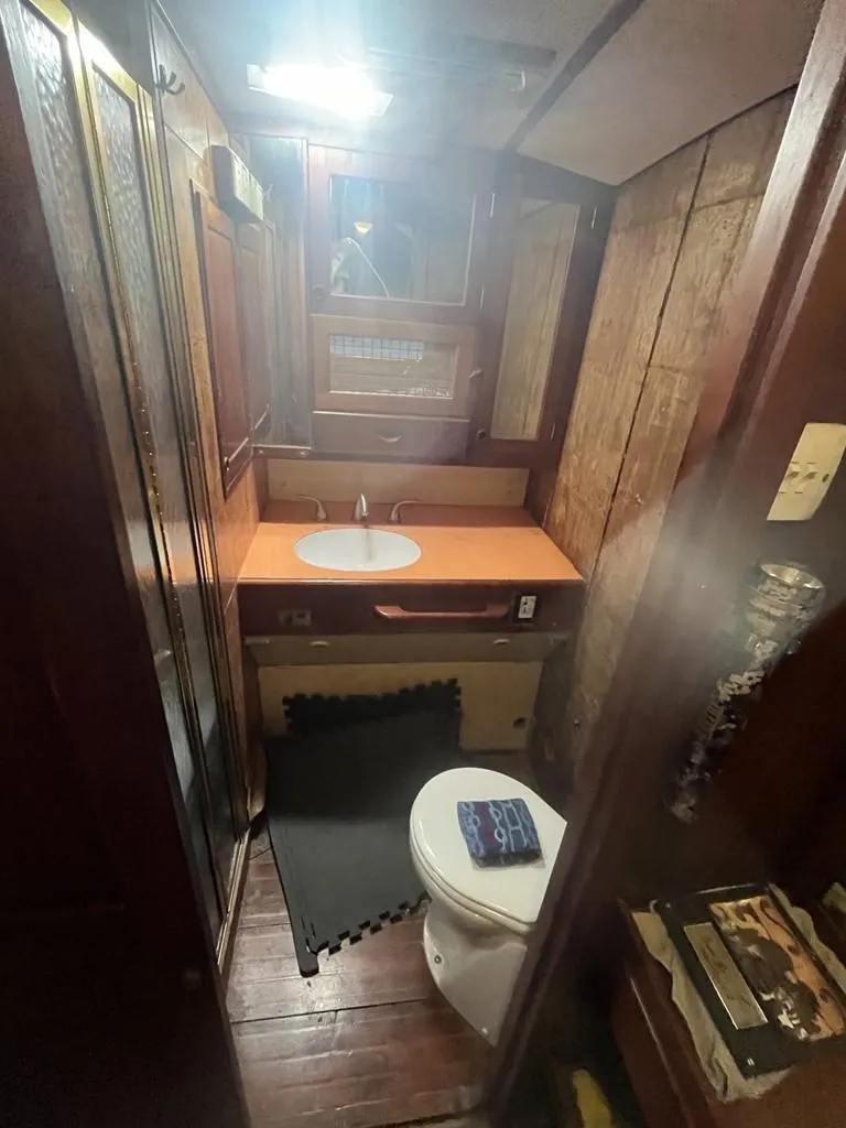 Slide: The Image of 1975 Cheoy Lee Offshore 53 MS yacht bathroom with wood paneling and compact design. - 42