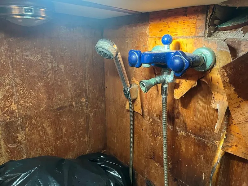 Slide: The Image of Vintage 1975 Cheoy Lee Offshore 53 MS shower with blue fixtures and wooden paneling. - 43