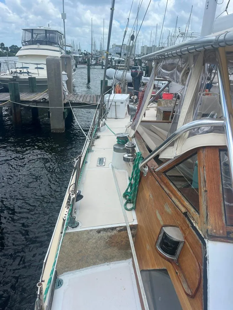 Slide: The Image of 1975 Cheoy Lee Offshore 53 MS sailboat docked at marina, showcasing deck and cabin details. - 5