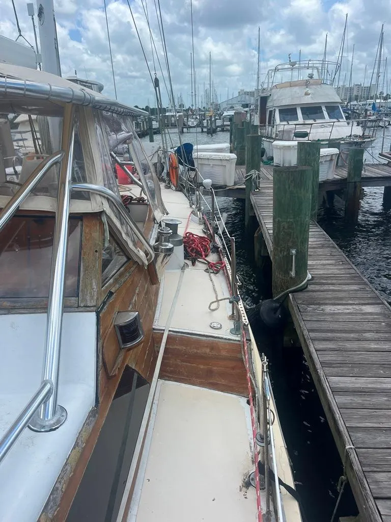 Slide: The Image of 1975 Cheoy Lee Offshore 53 MS sailboat docked at marina under cloudy sky. - 6