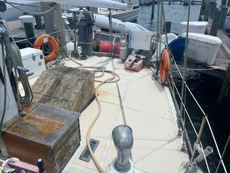 Slide: The Image of 1975 Cheoy Lee Offshore 53 MS sailboat deck with nautical equipment and lifebuoys at dock. - 8